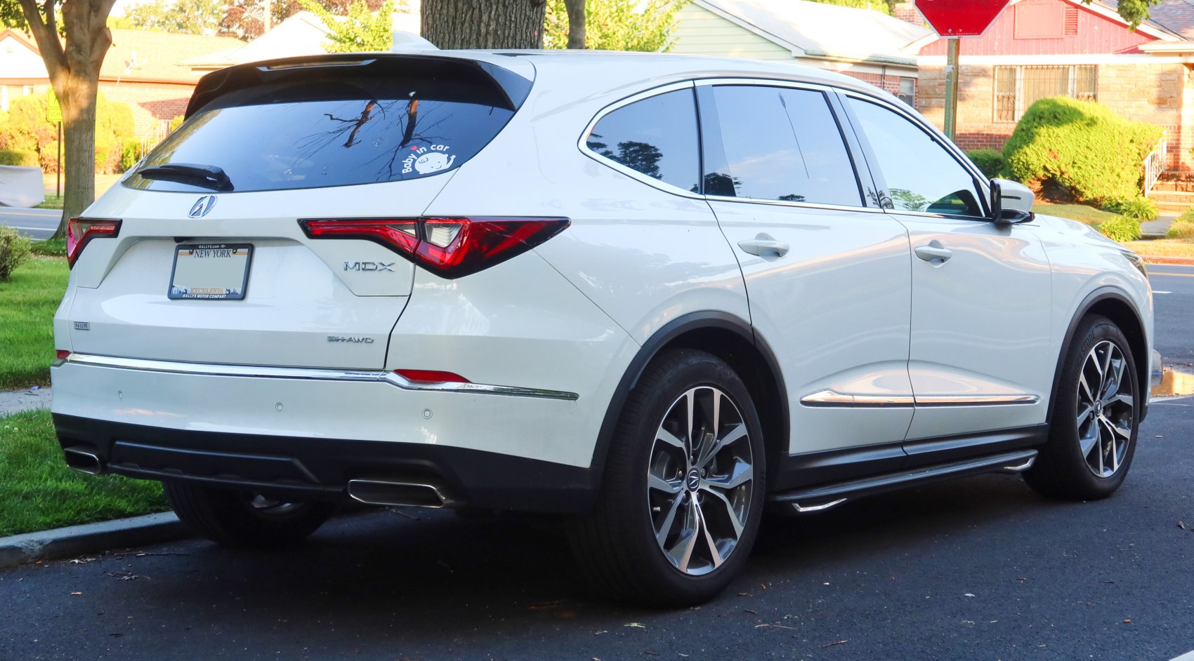SUV rear design with angular tail lights, chrome trim, and dual exhaust.