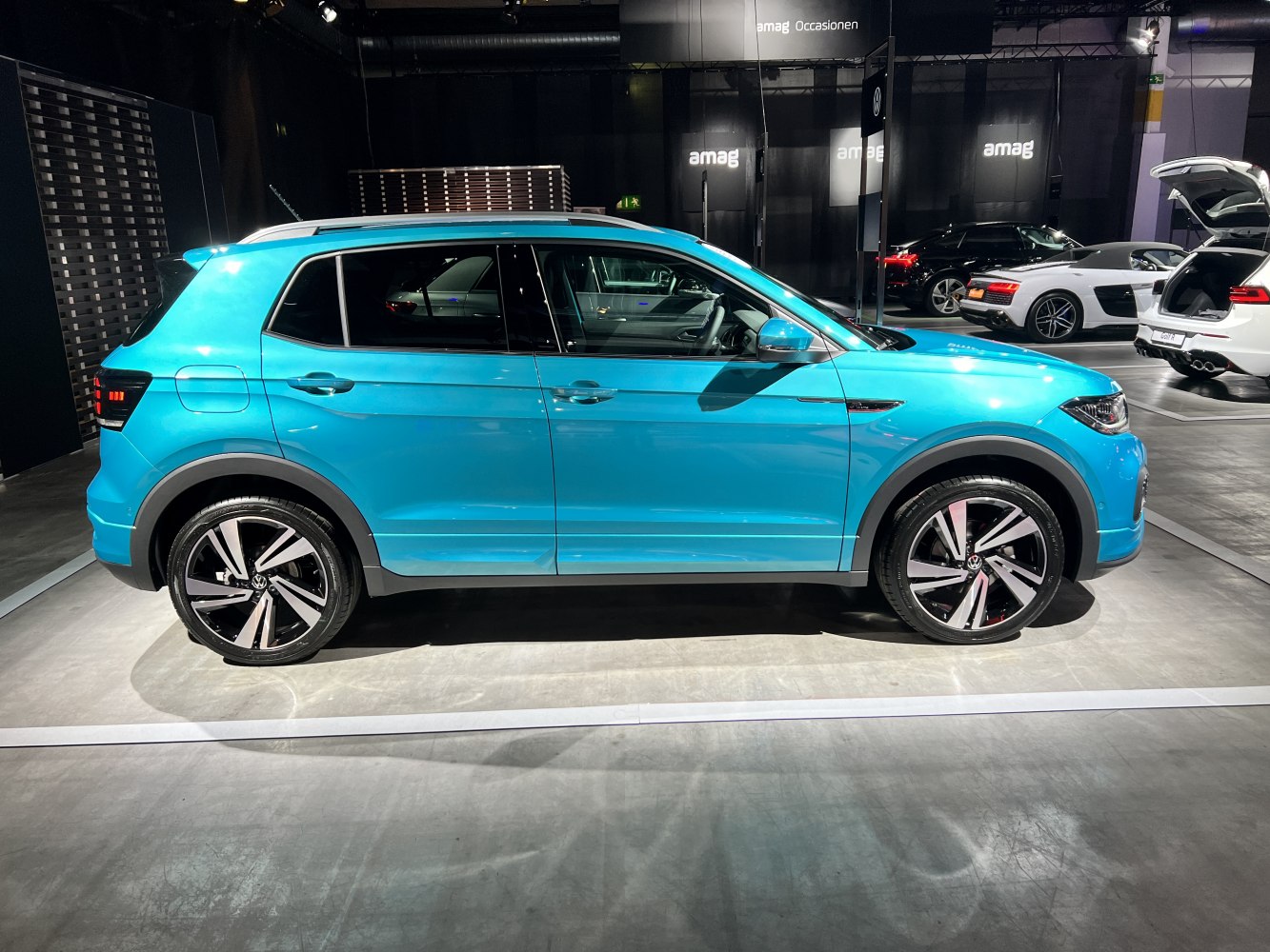 Compact SUV side profile with distinctive alloy wheels and sleek stadium lighting.