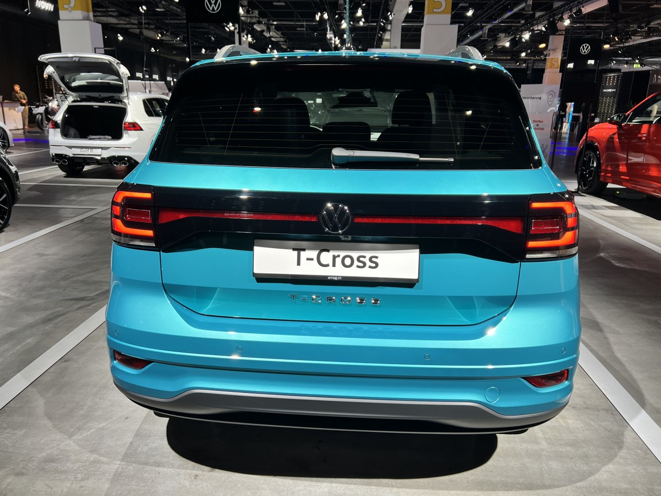 Rear view with illuminated taillights and rear design of a compact SUV