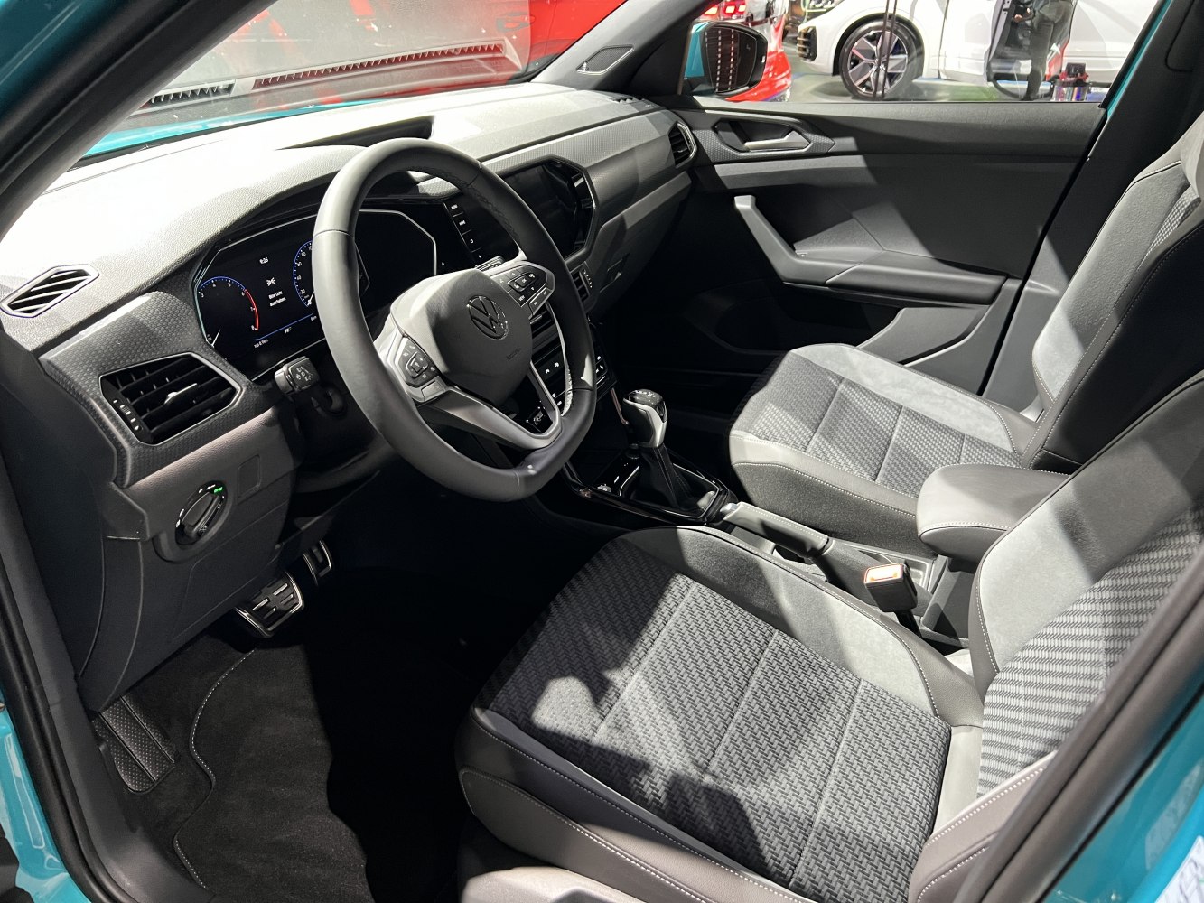 Modern car interior with digital dashboard and fabric seats