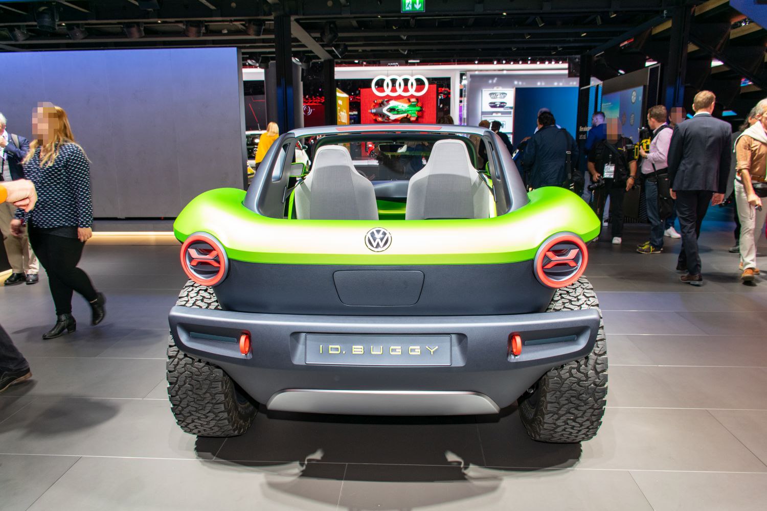 Rear view of open-roof electric buggy with round taillights and rugged off-road tires