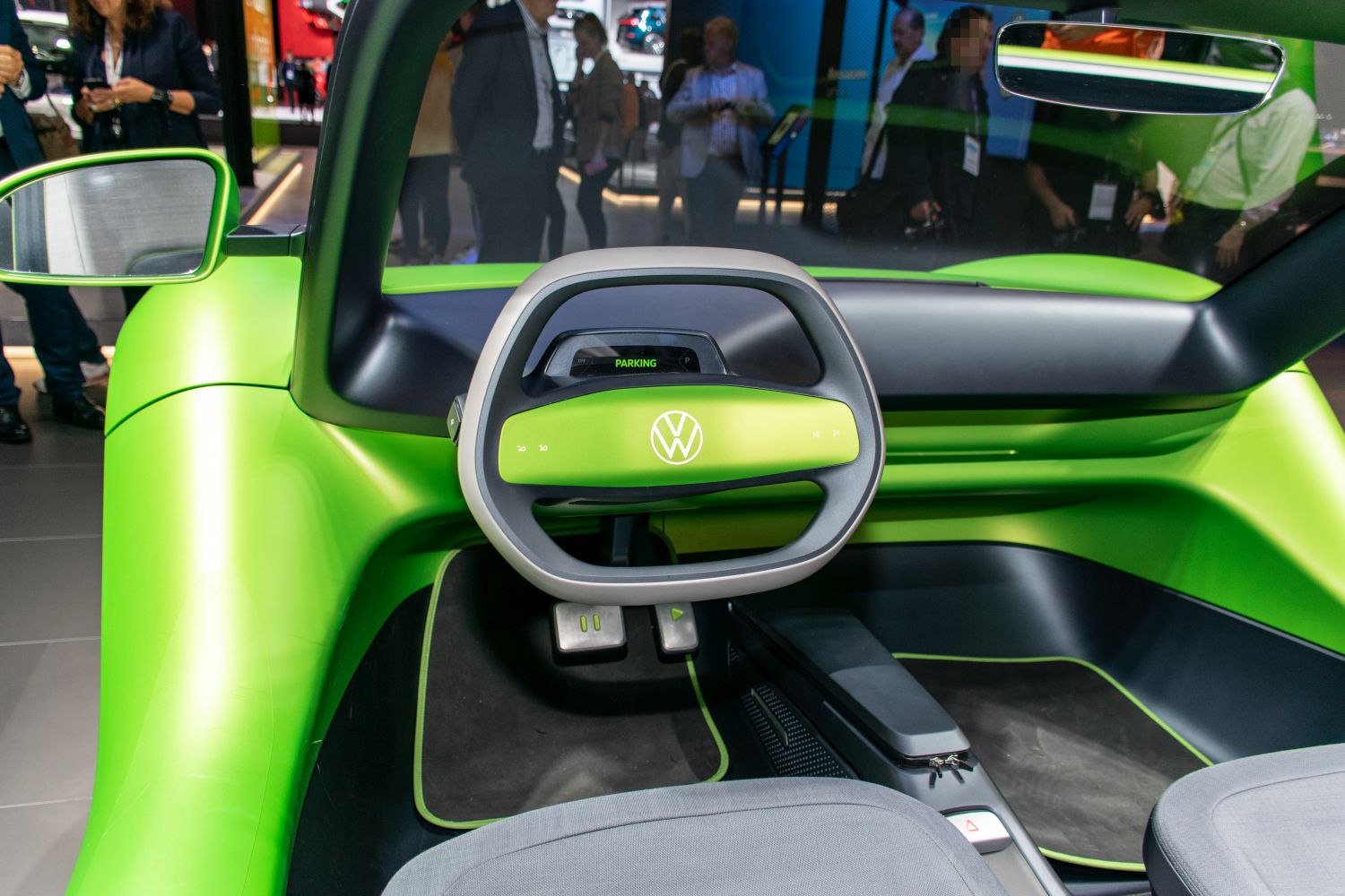 Futuristic steering wheel and minimalist green interior with digital display