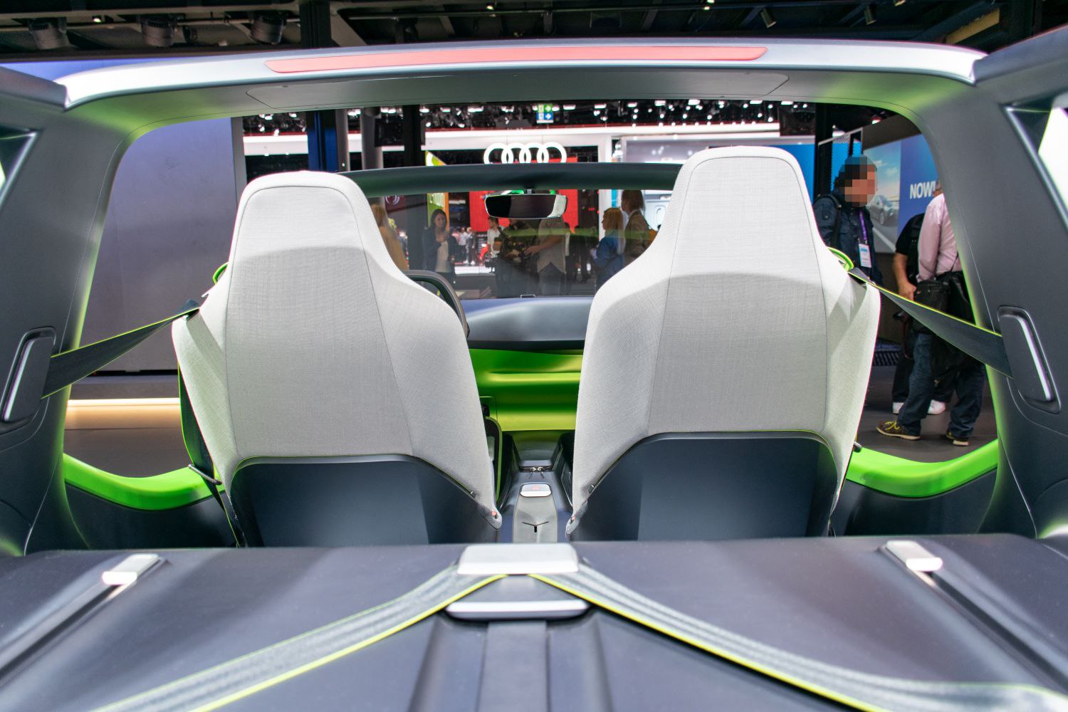 Two-tone fabric seats and green-accented minimalist open interior design