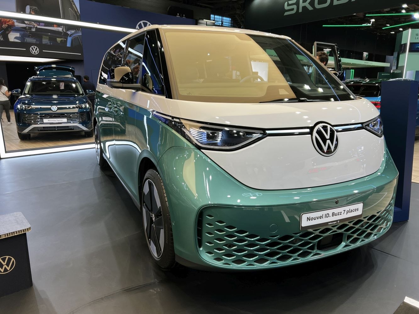 Front view of futuristic electric minivan with LED headlights and unique grille.