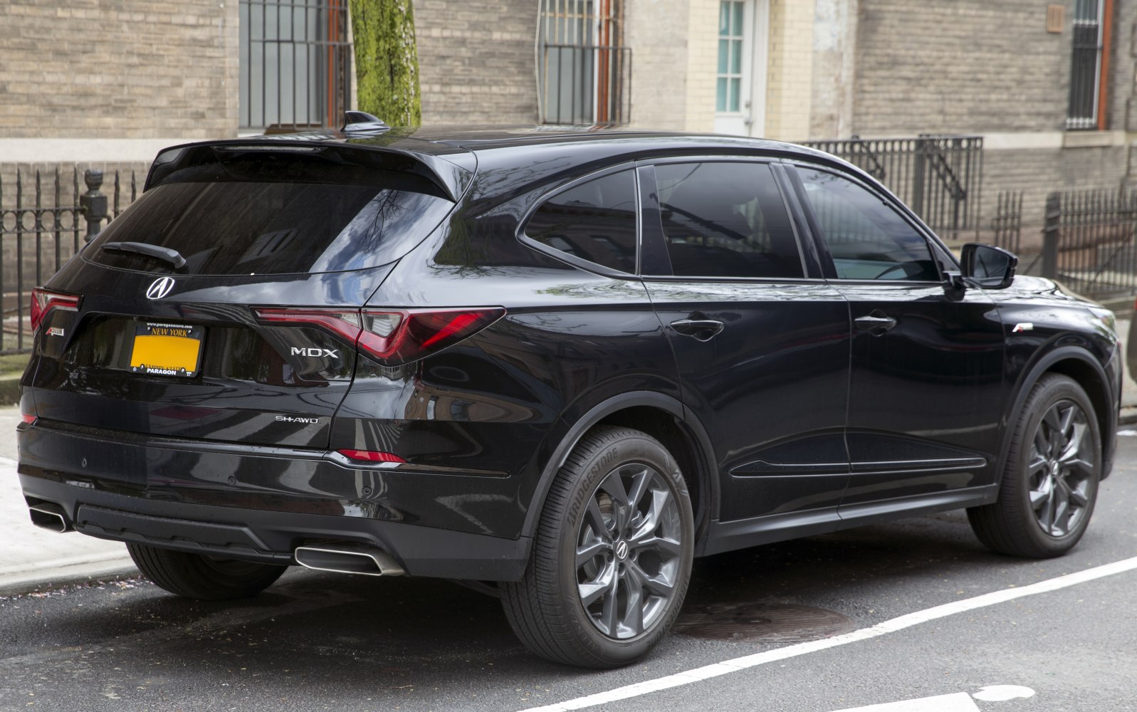 Rear and side view of a black SUV with modern tail lights and sporty alloy wheels