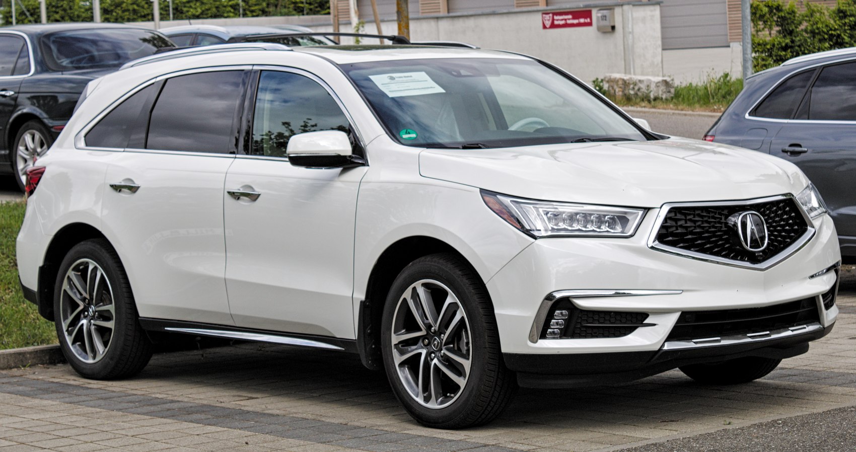 LED headlights and pentagonal grille on luxury SUV front side