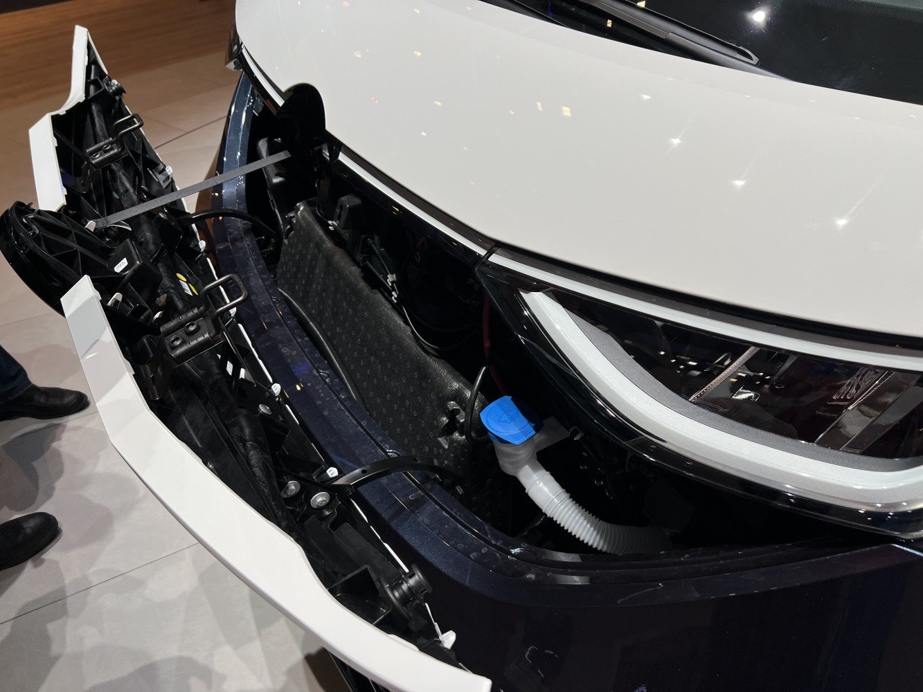 Opened front panel with headlight and internal component view