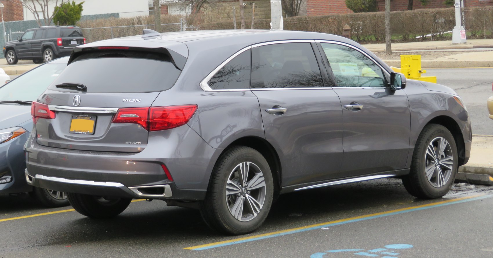 Rear and side view of a gray SUV with distinct taillights and alloy wheels