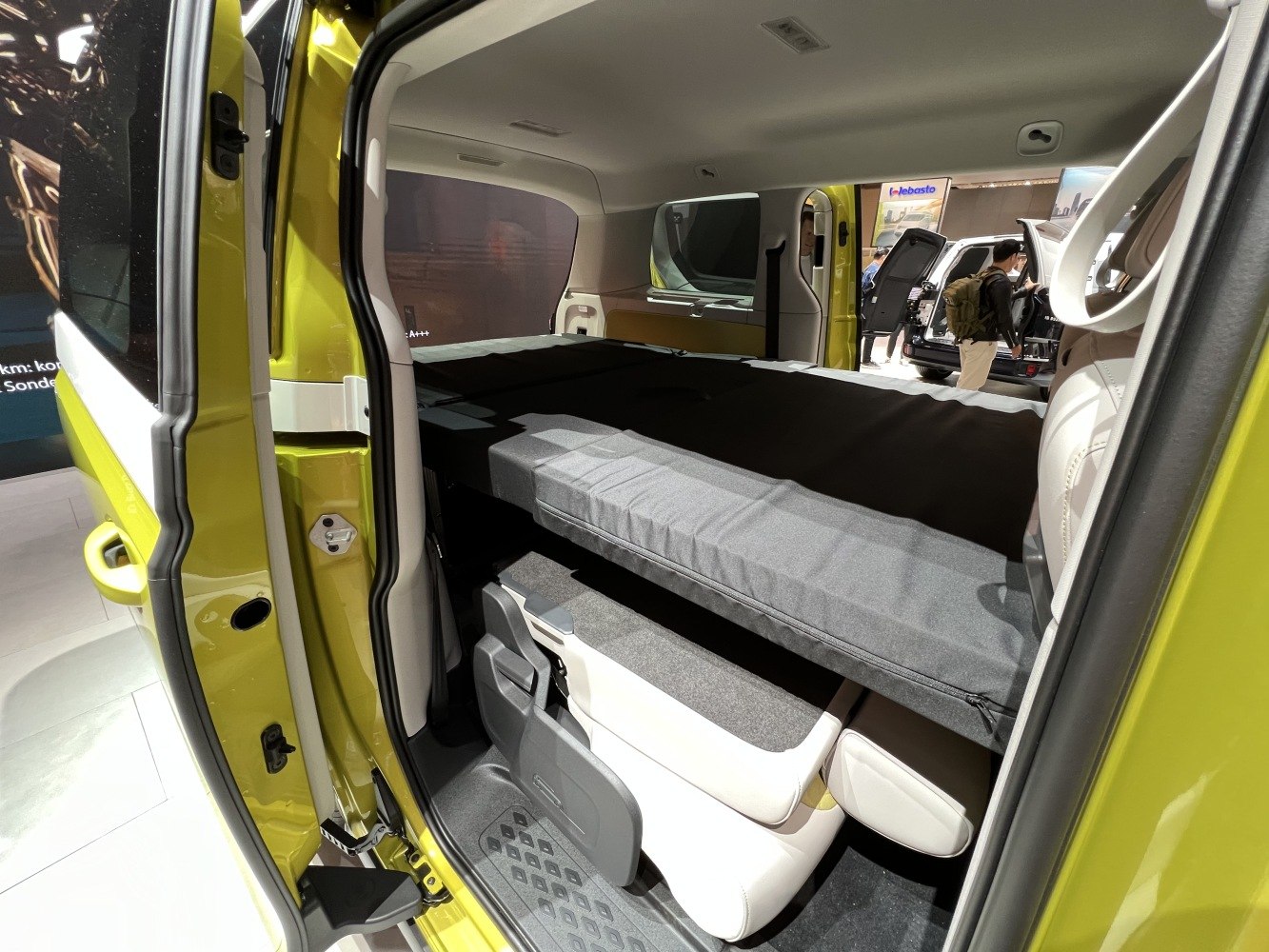 Folded seats creating a flat sleeping and cargo area inside a van