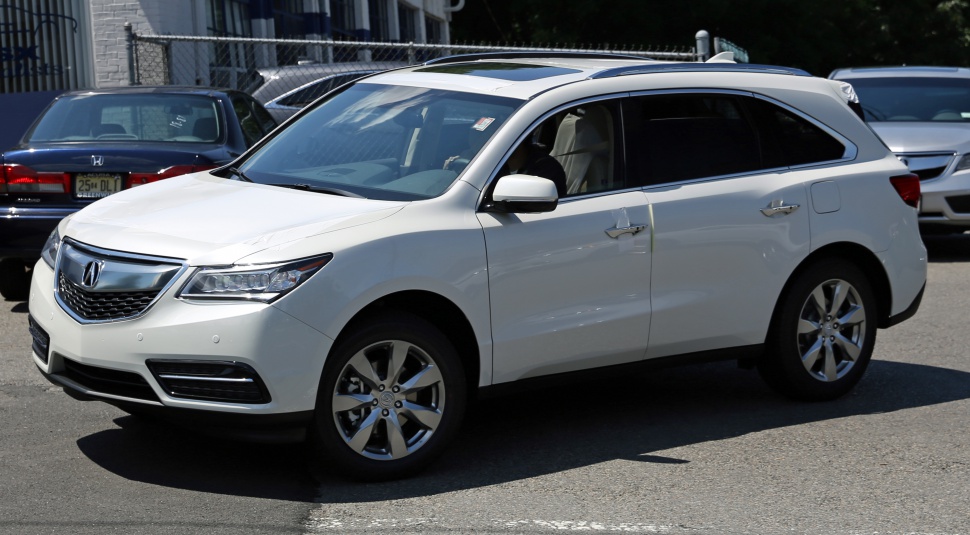 Front side profile of white mid-size SUV with modern grille and smooth body lines