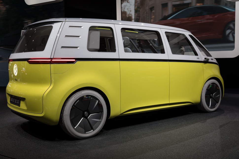 Two-tone futuristic electric microbus with sleek, modern design and large wheels