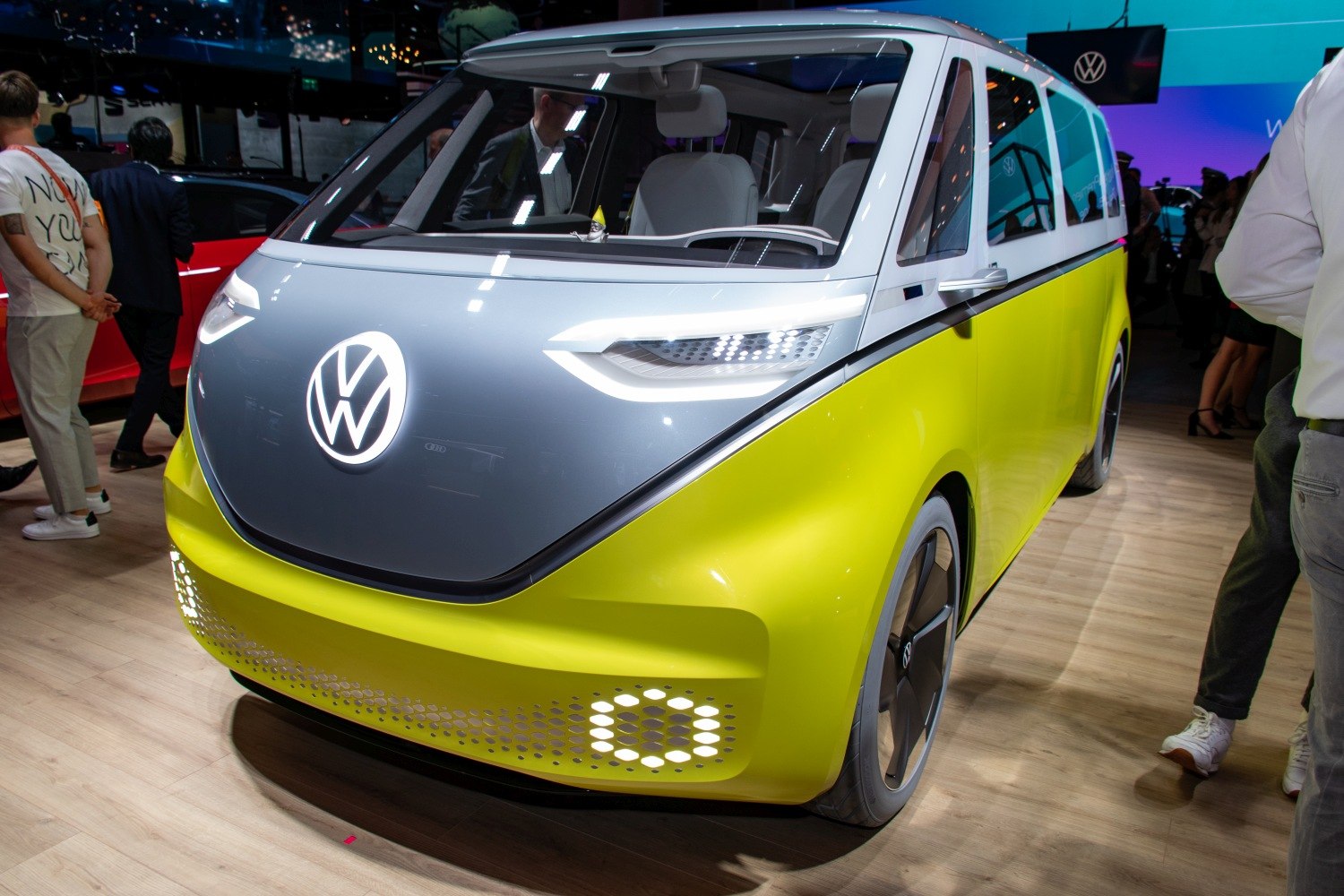 Futuristic electric van front with LED headlights and illuminated logo