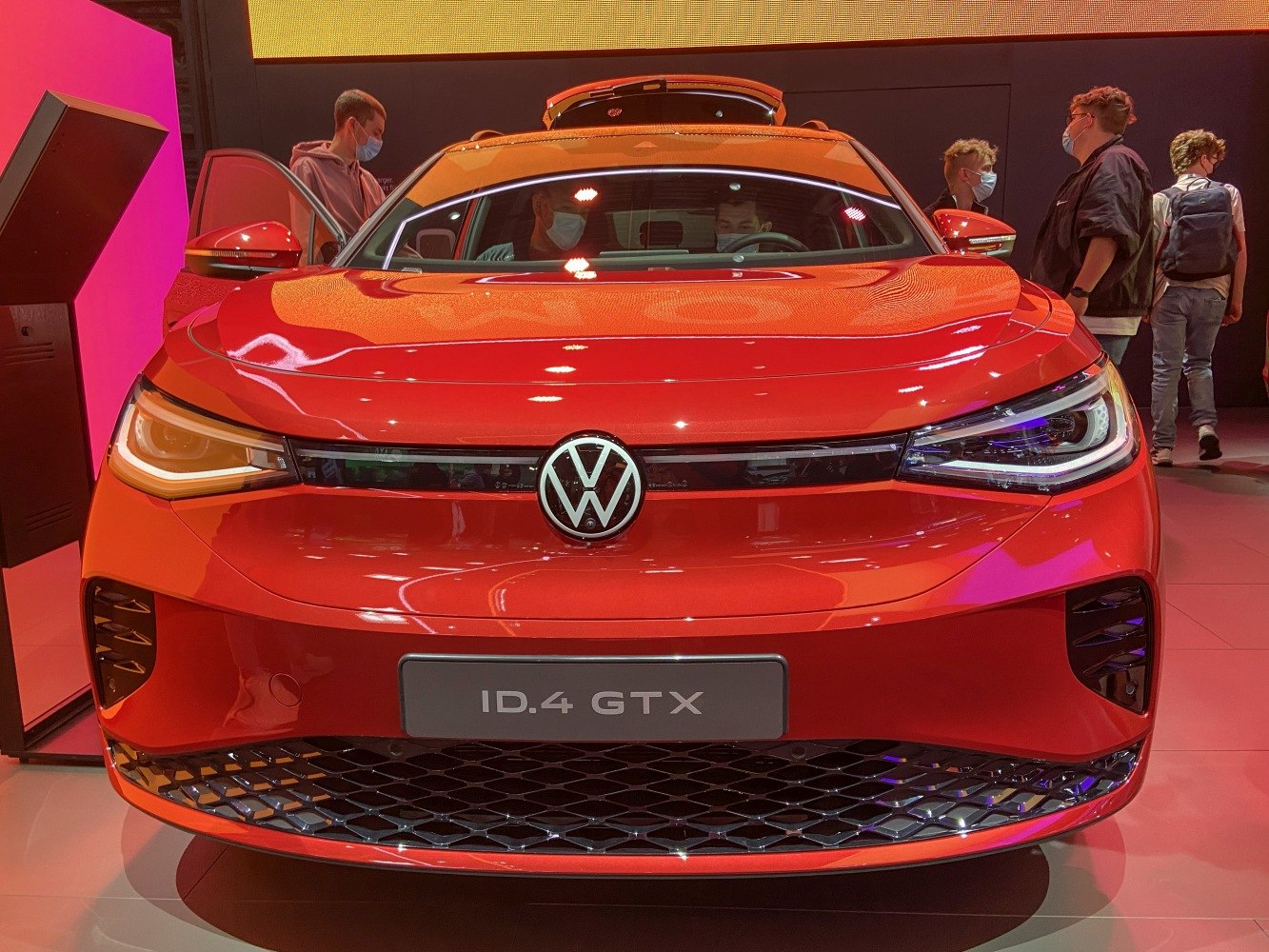 Red electric SUV front with LED headlights and VW emblem