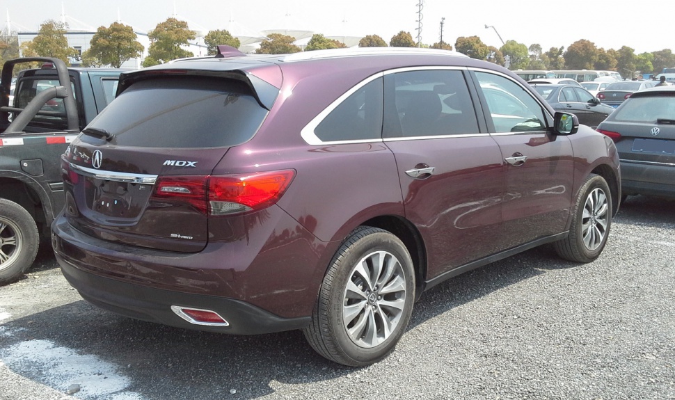 Rear side view of SUV with tinted windows and alloy wheels