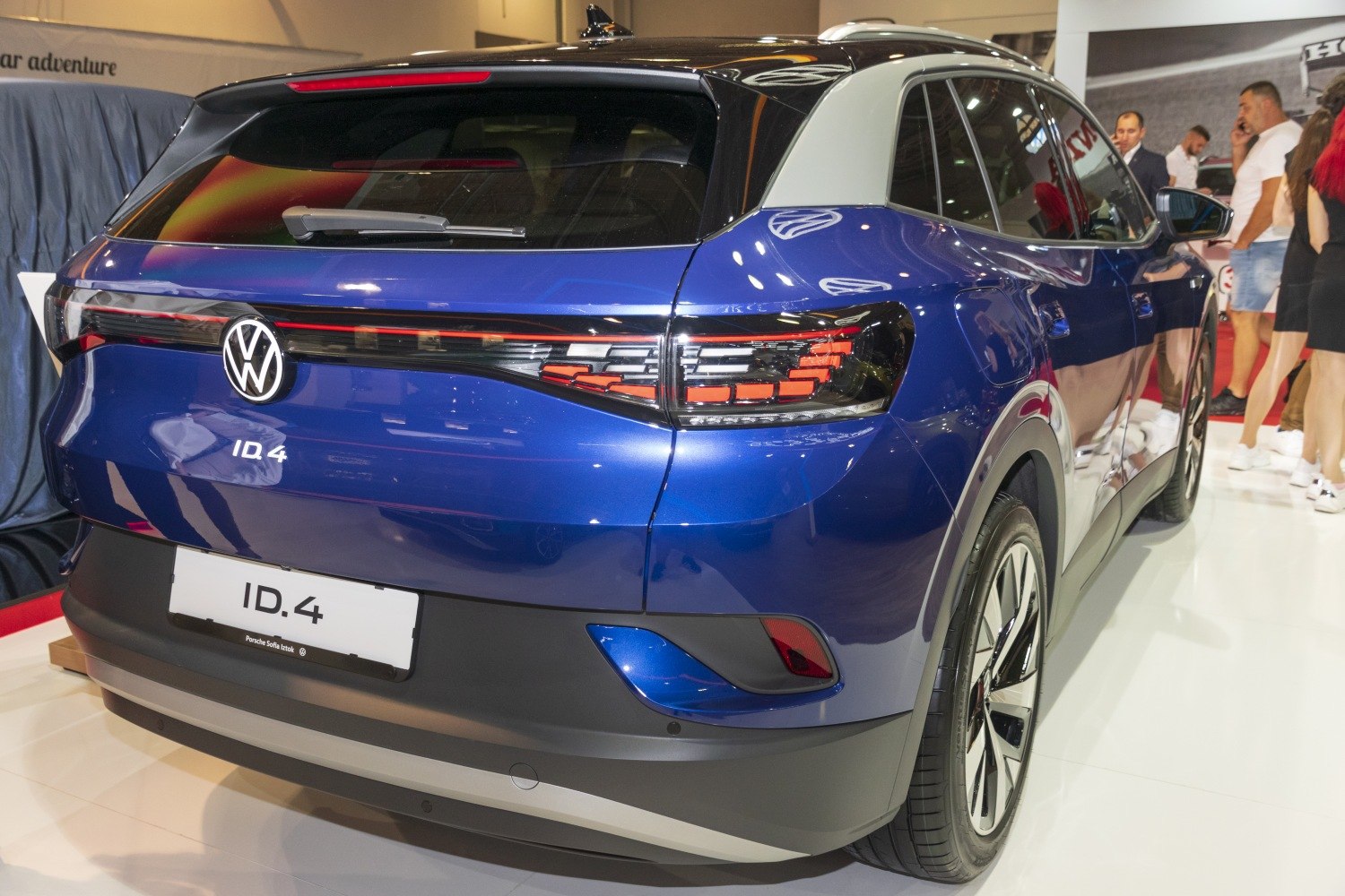 Rear view of blue electric SUV with LED tail lights and rear wiper