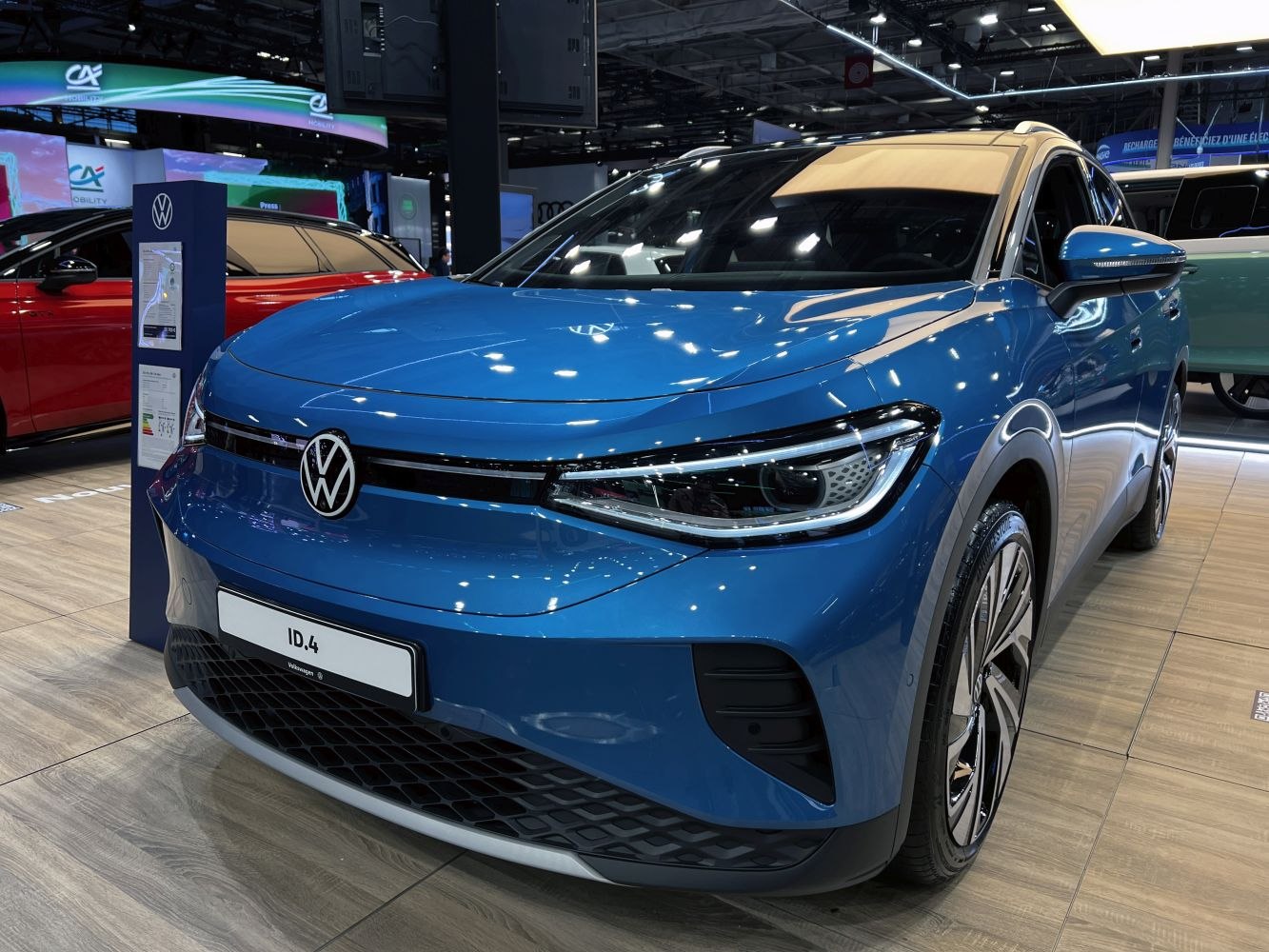 Blue electric SUV front view with LED headlights and aerodynamic design