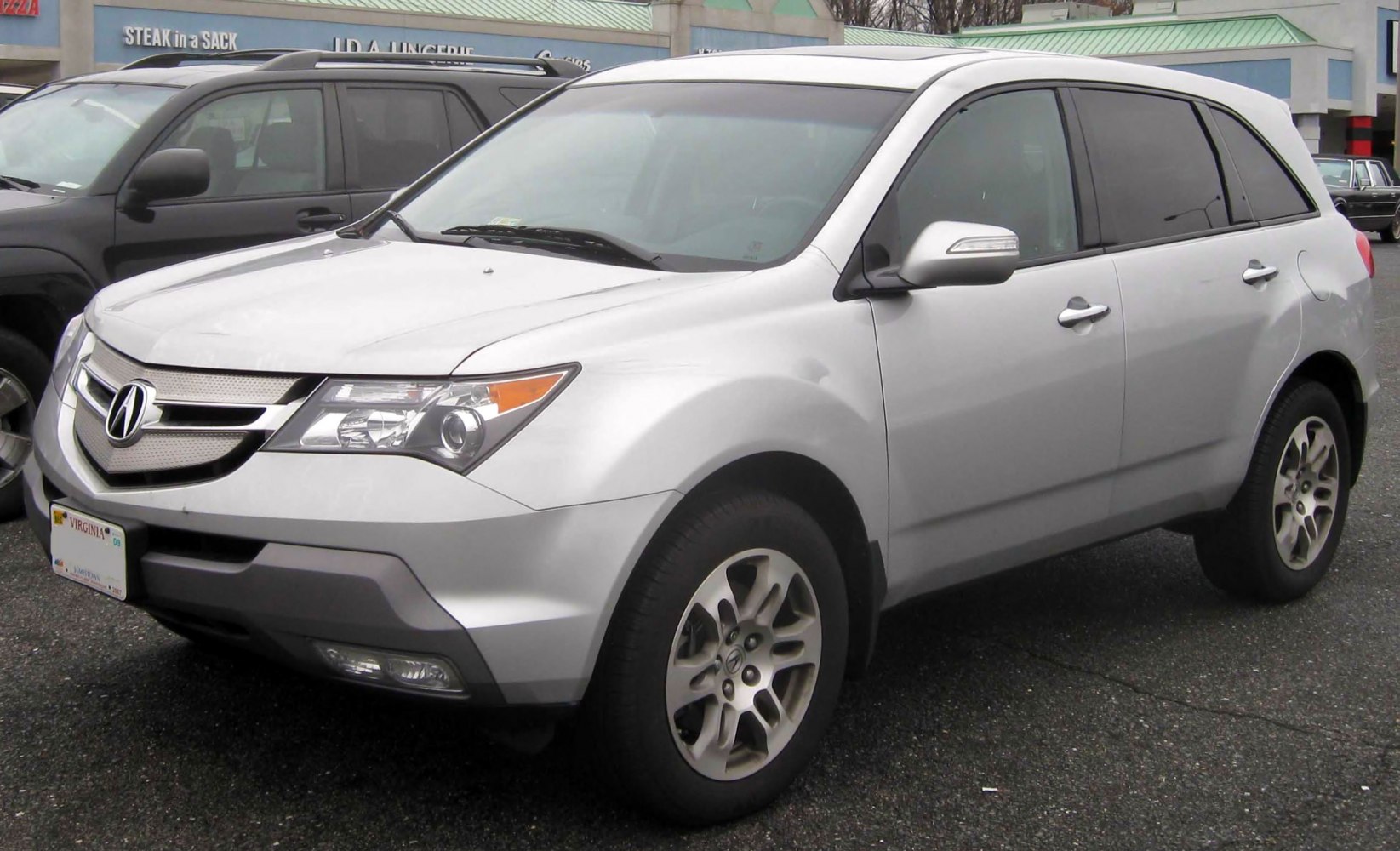 Silver SUV front side with alloy wheels and tinted windows