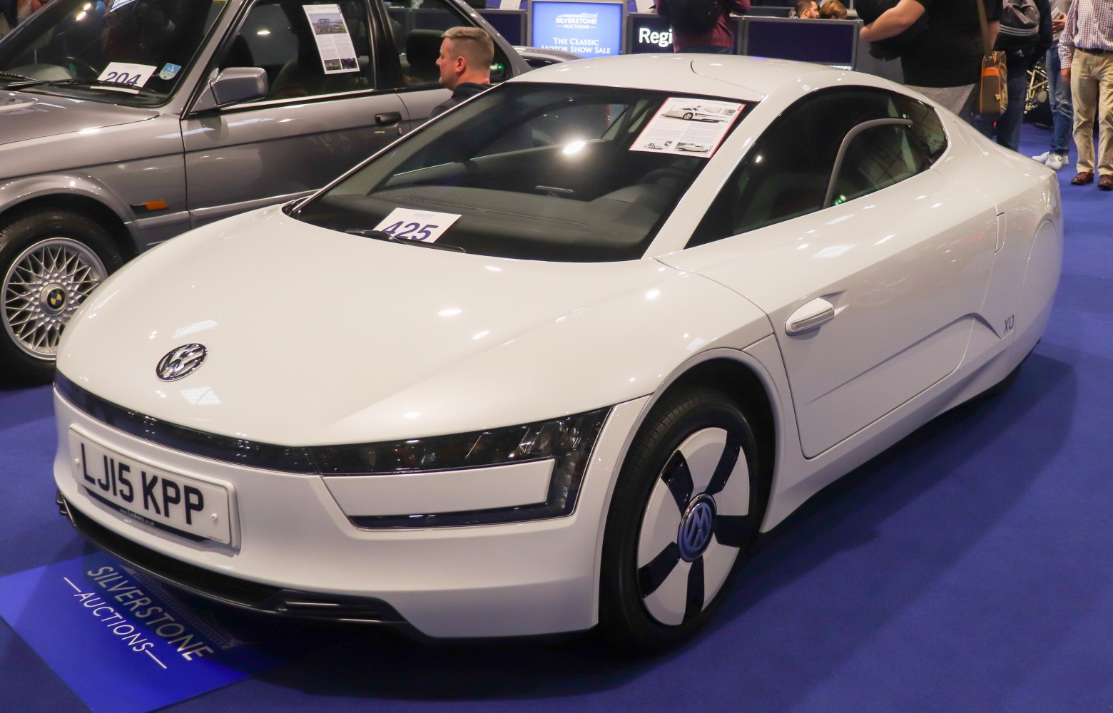 Futuristic aerodynamic white vehicle with sleek body and low drag wheels