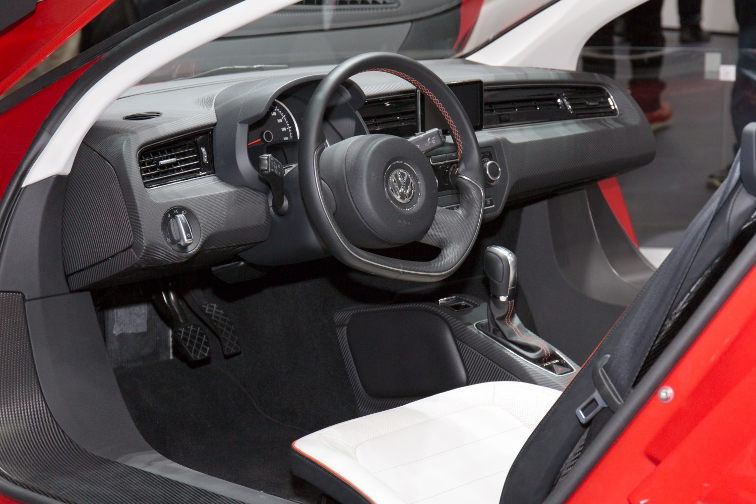 Dashboard, steering wheel, gear shift, and pedals inside a car