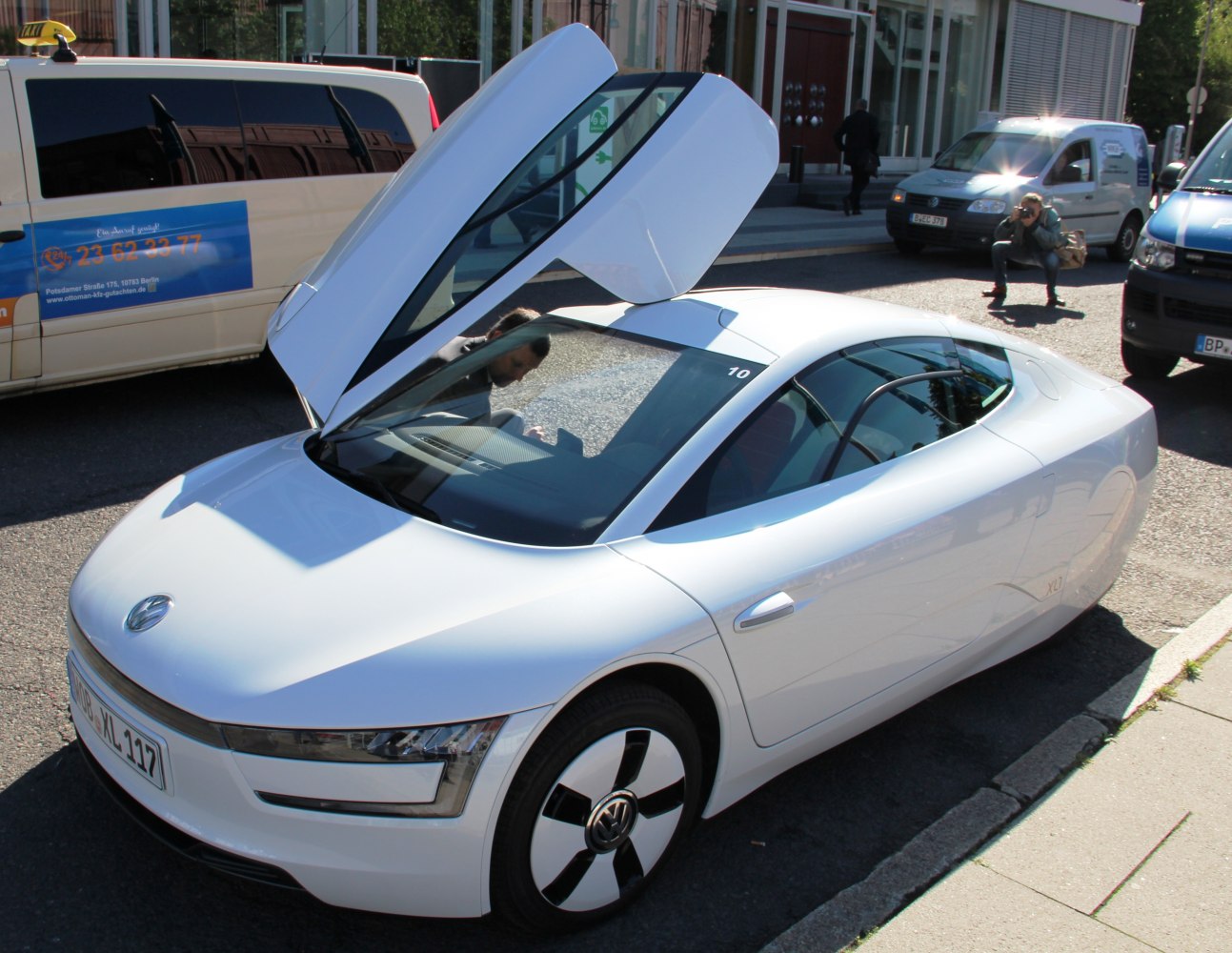 Car with unique gullwing doors and aerodynamic sleek body design