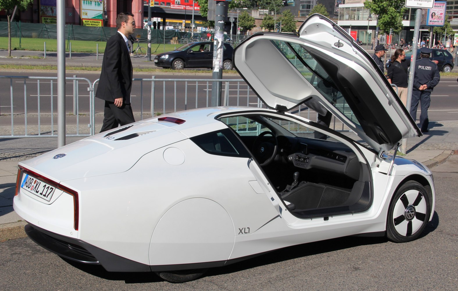 Futuristic aerodynamic white vehicle with gullwing door open