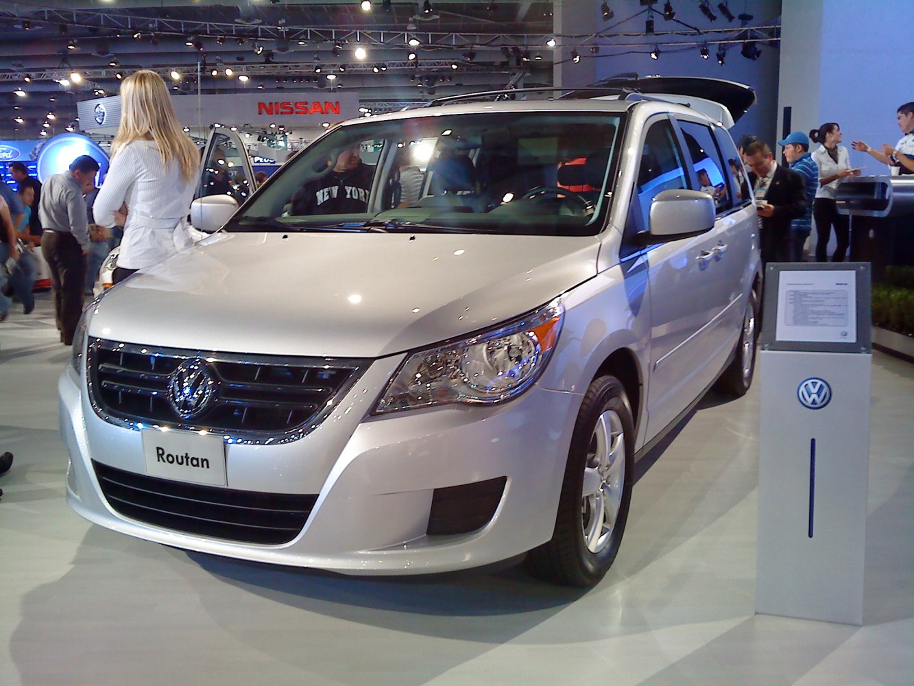 Front view of silver minivan with grille and headlights