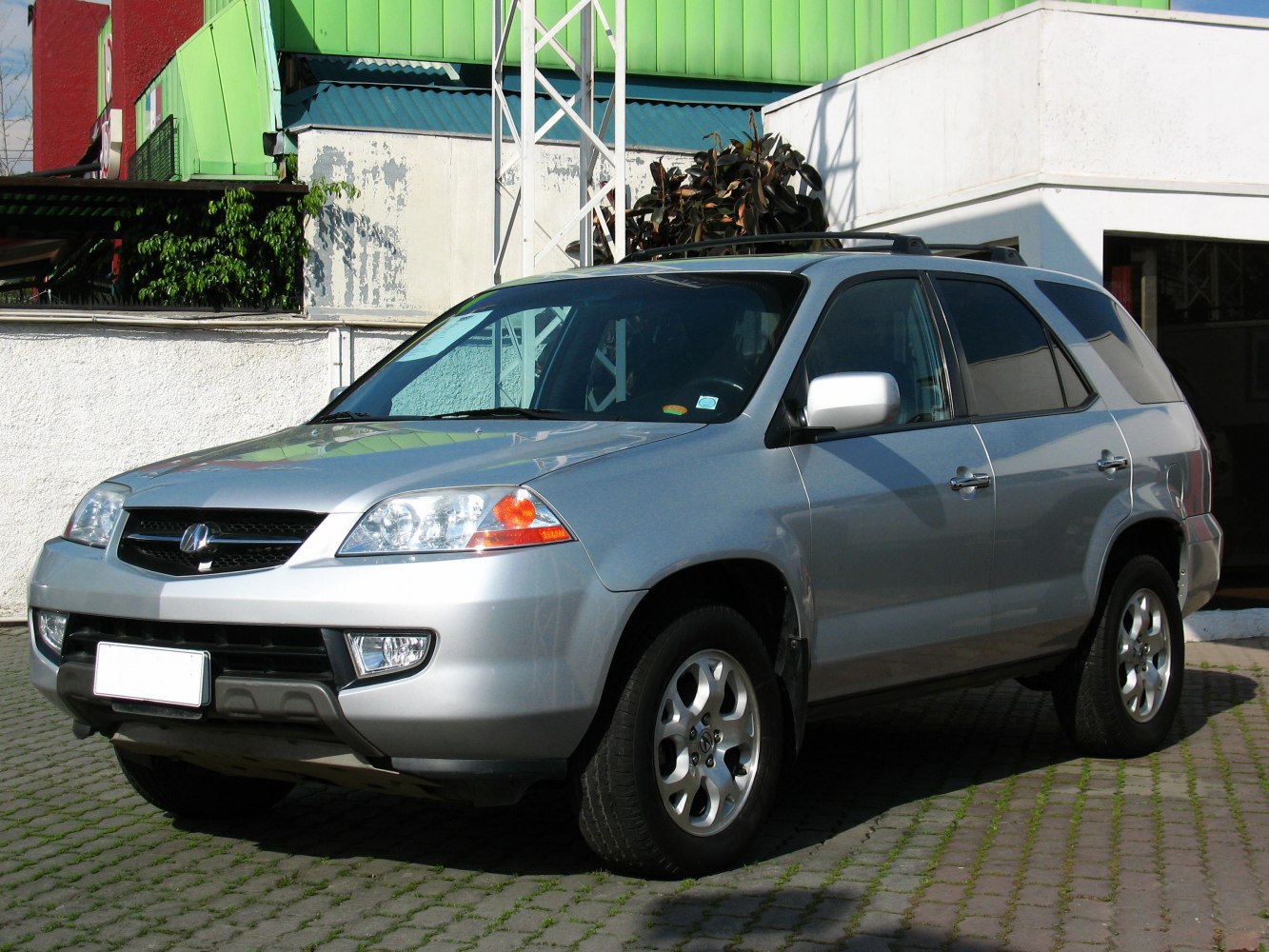 Silver SUV with front side view and alloy wheels.