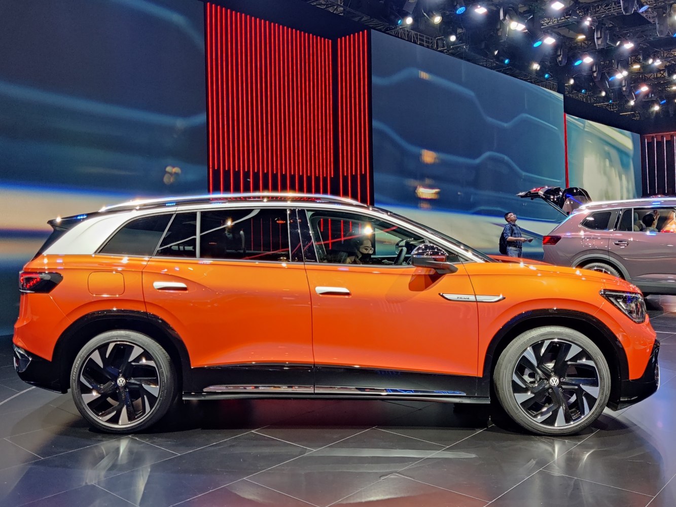 Orange electric SUV with black alloy wheels and chrome trim side profile