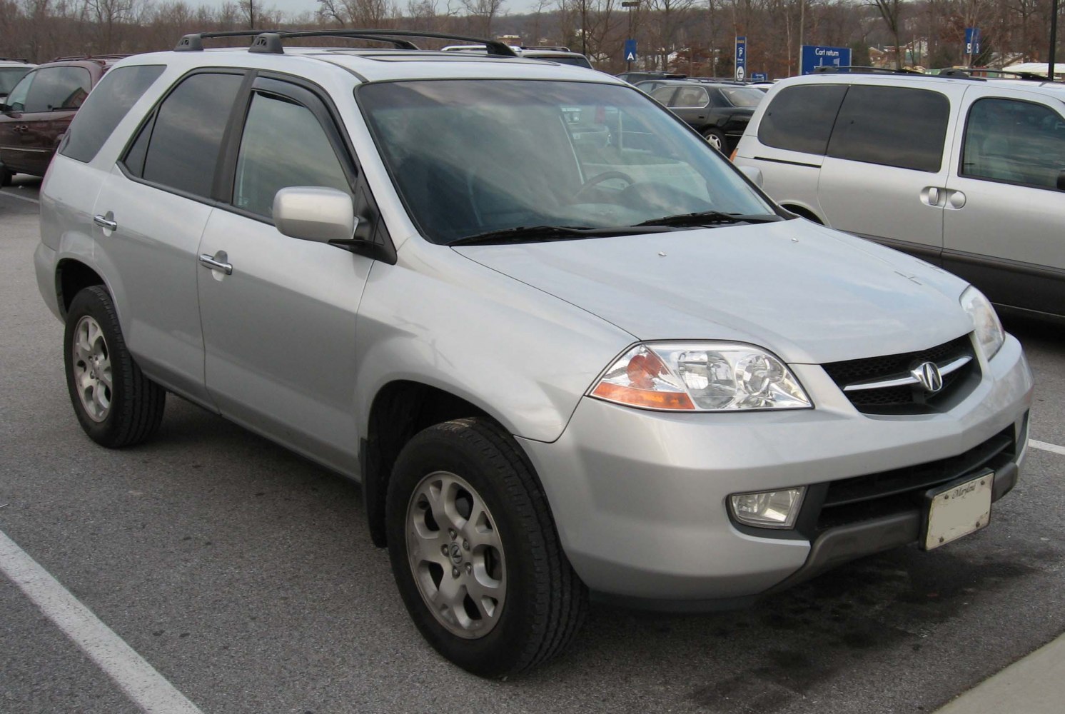 Silver SUV front three-quarter view with detailed headlights and alloy wheels