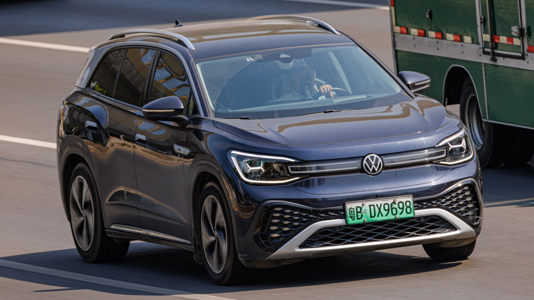 Front view of modern electric SUV with LED headlights and roof rails