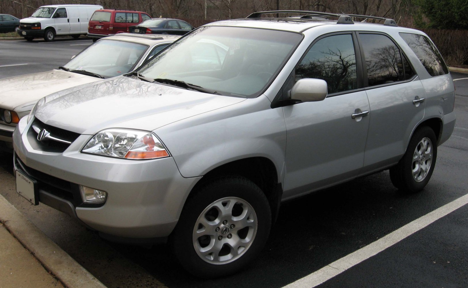 Silver metallic SUV front side profile with roof rack and detailed headlights