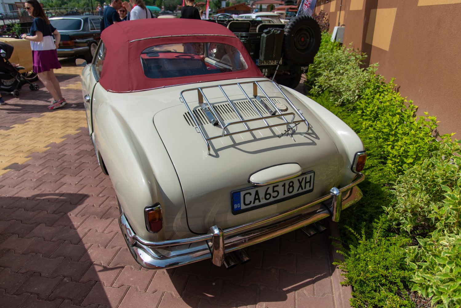 Convertible with red soft top and chrome luggage rack