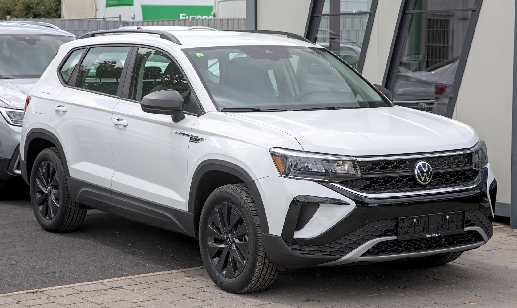 Front and side exterior view of an SUV with black grille and roof rails