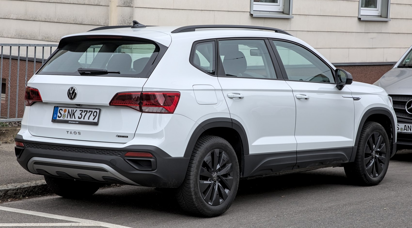 Rear and side view of a compact SUV with black alloy wheels