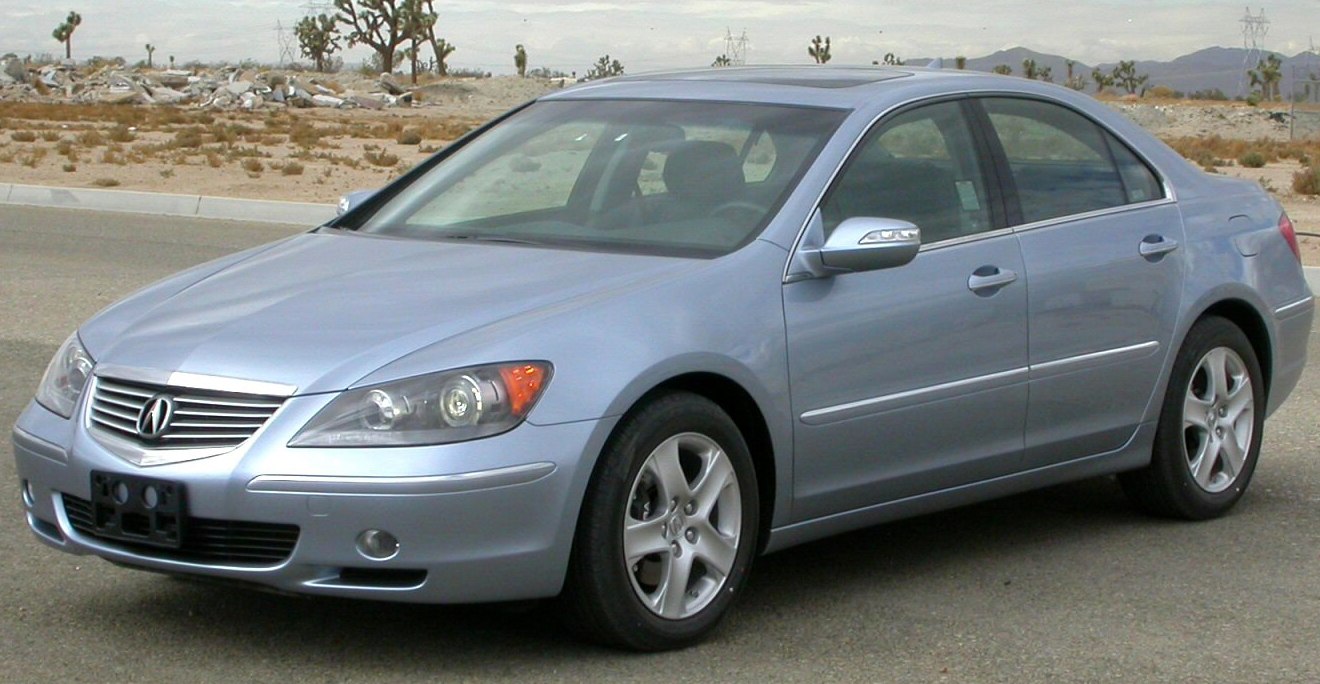 Front side view of a mid-2000s luxury sedan with sleek headlights and alloy wheels