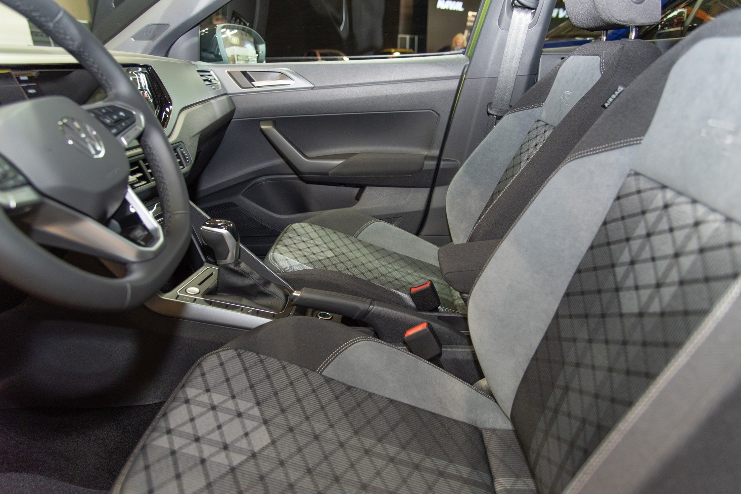 Front seats and dashboard with patterned upholstery and gear shift