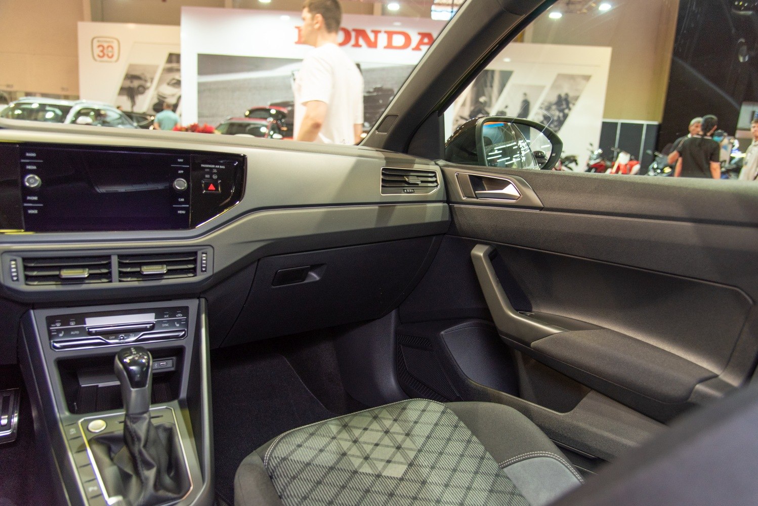 Modern car interior with dashboard, gear shifter, and passenger seat