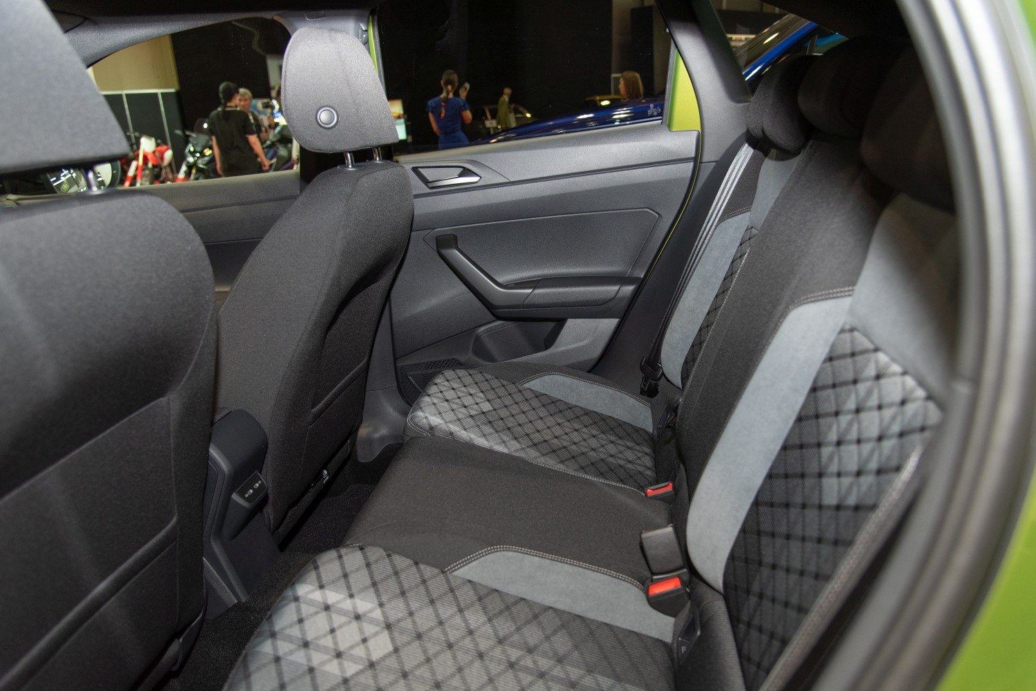Rear seat interior with quilted upholstery and modern ergonomic design.