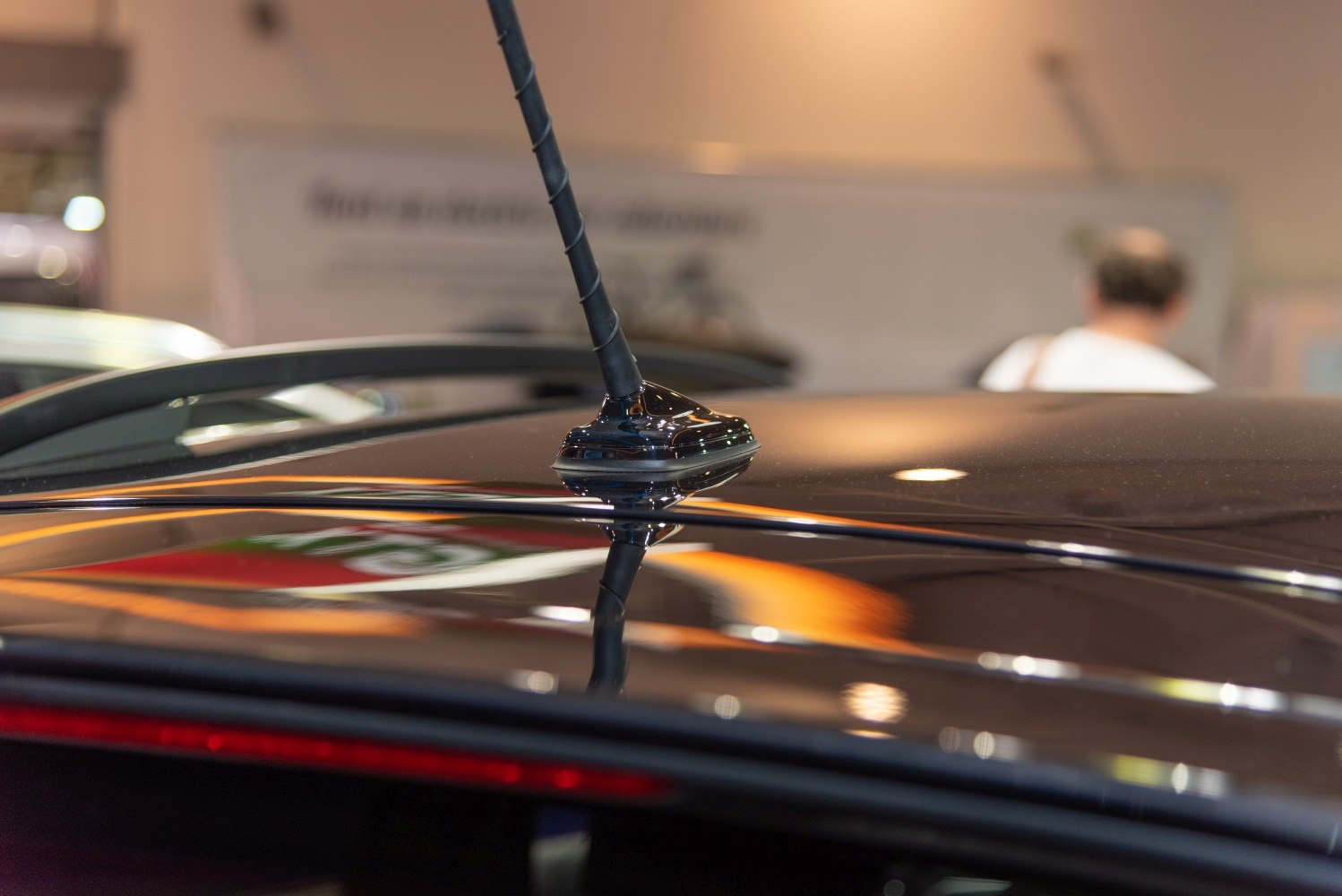Close-up of a spiral roof antenna on a glossy car roof
