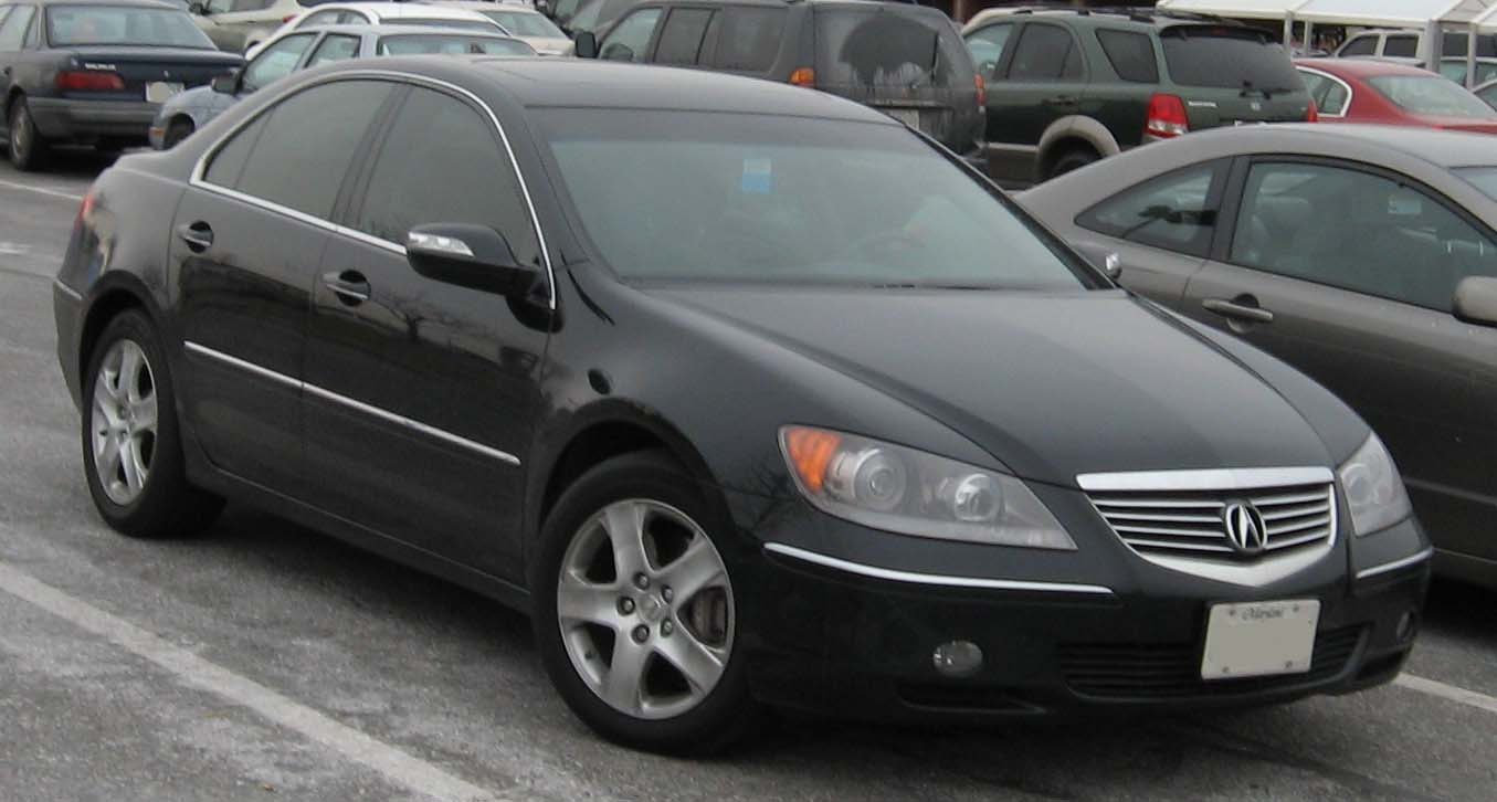 Black luxury sedan front-side view with signature grille and alloy wheels