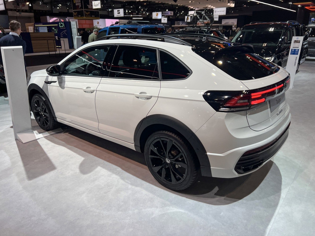 Rear-side view with black alloy wheels and sleek rear lights.