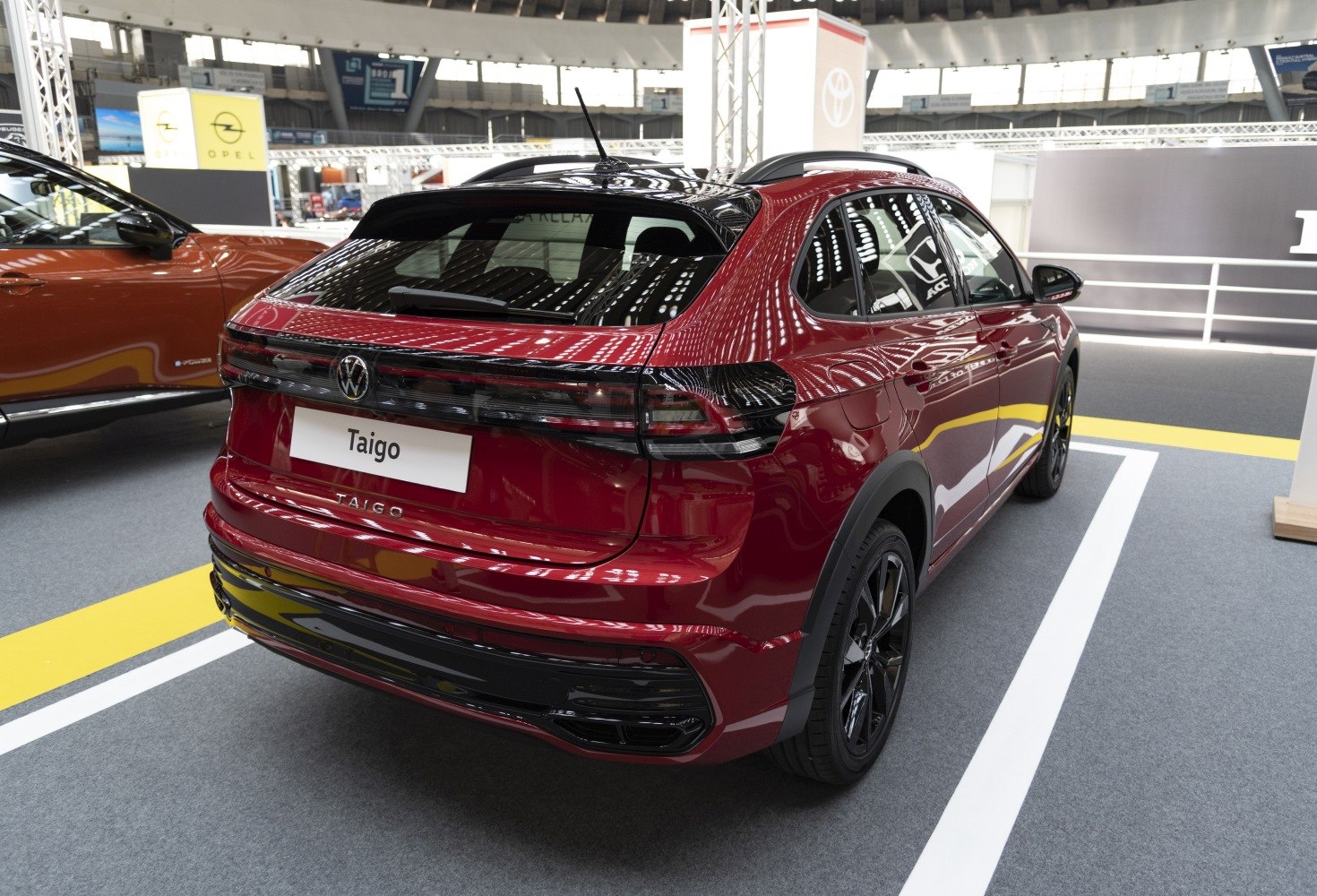 Rear view with sleek horizontal taillights, black trims, and a sporty design.