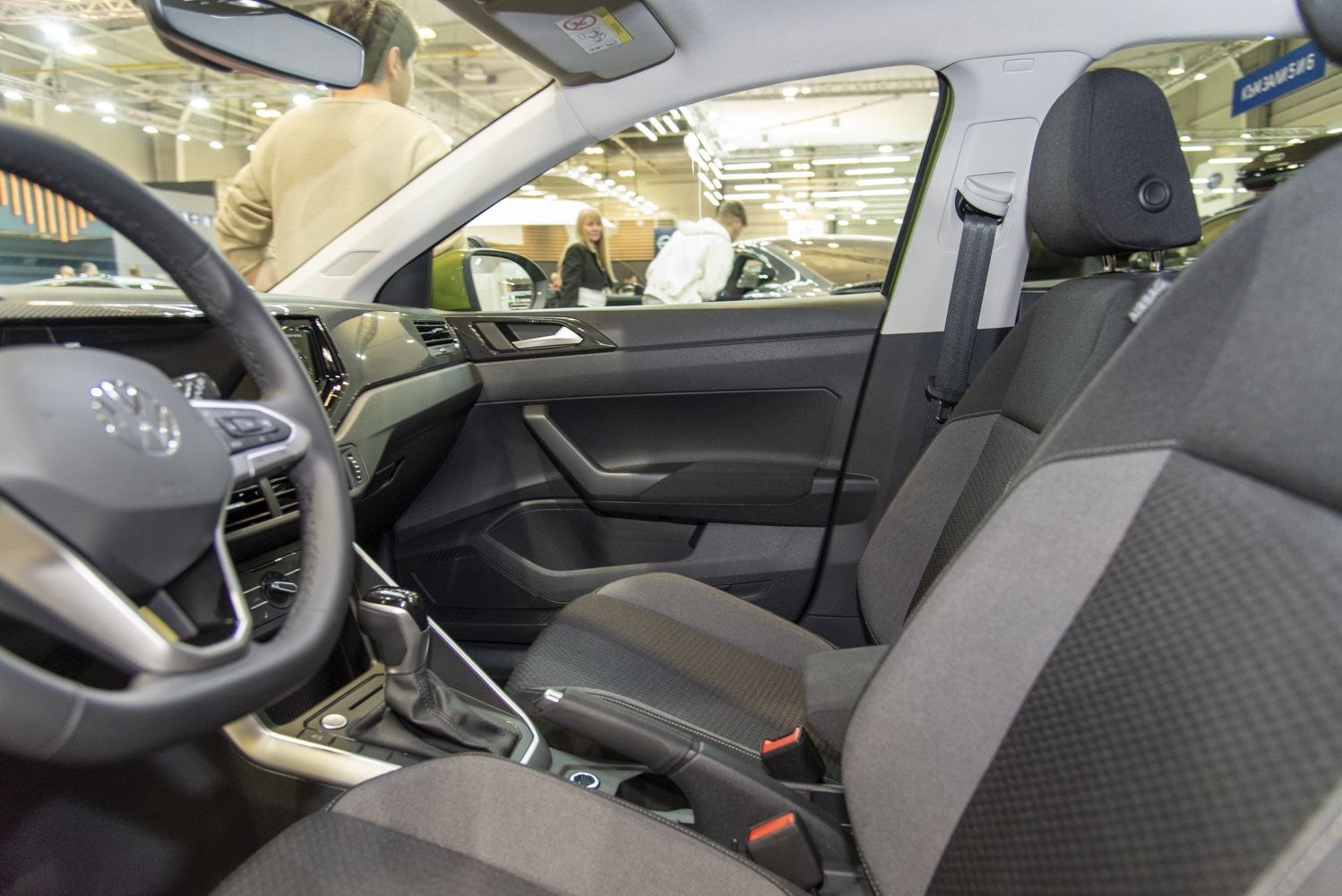 Modern car interior with steering wheel and front seats