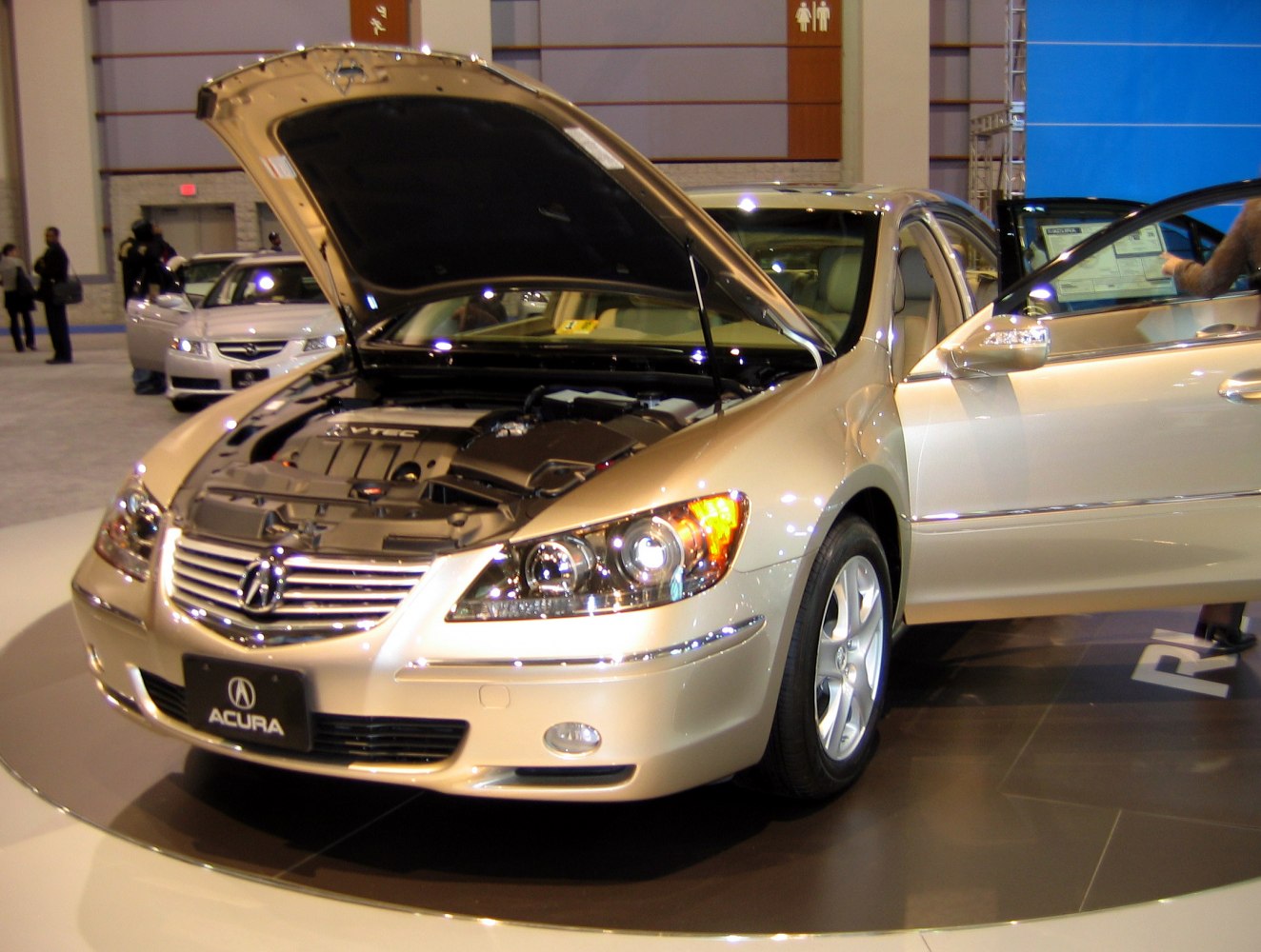 Open hood showing engine and open front door displaying interior