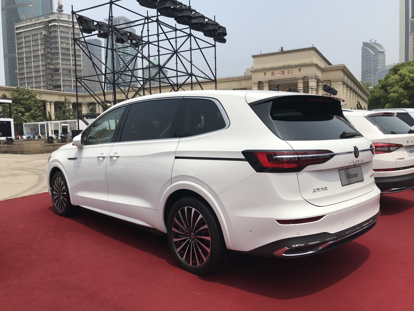Rear side view of a white vehicle with LED tail lights and alloy wheels