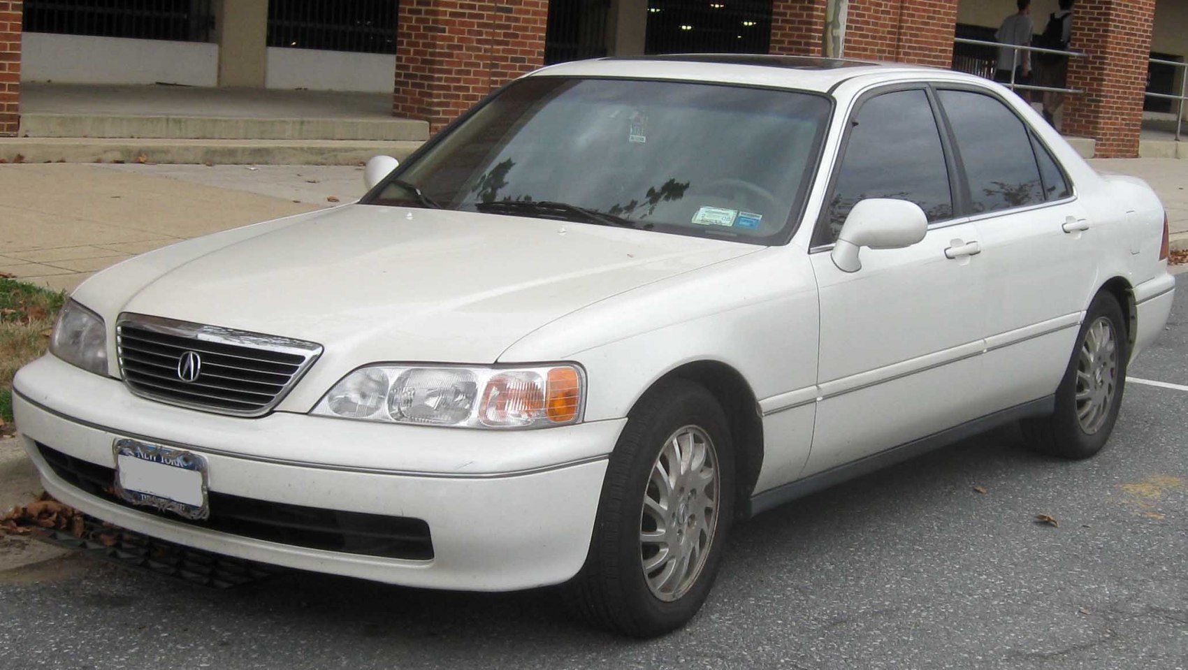 White 1996 sedan front and side exterior with rounded headlights and horizontal grille
