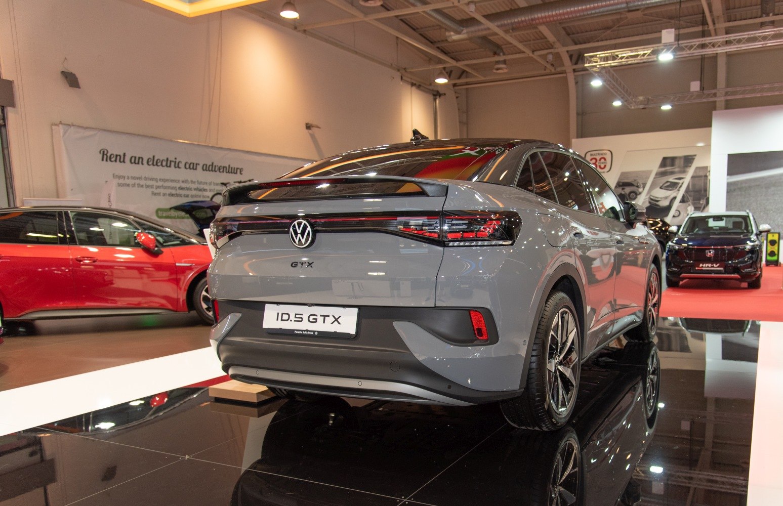 Rear view of modern electric SUV with distinct tail lights and rear spoiler