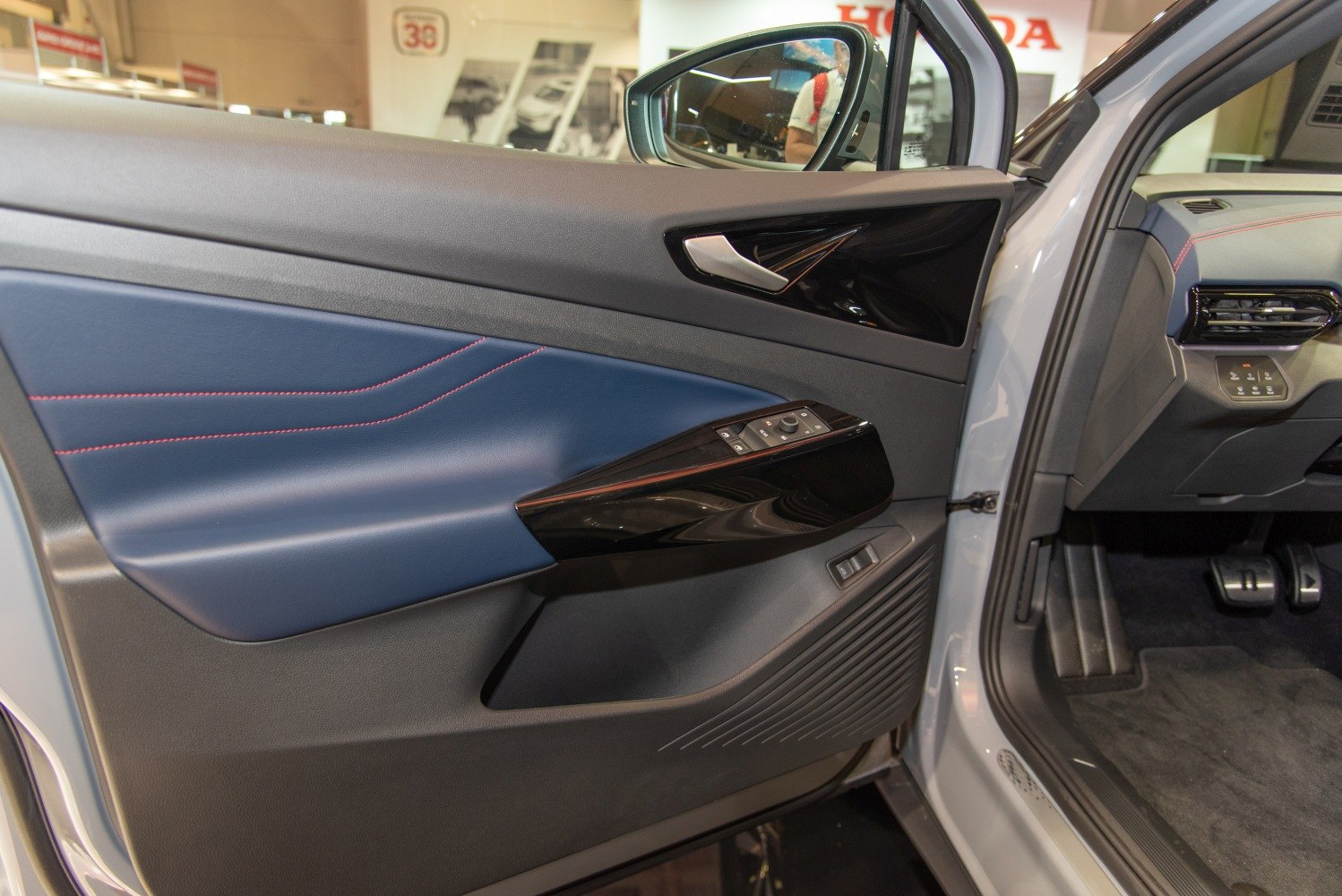 Close-up of car interior door panel with window controls and trim details