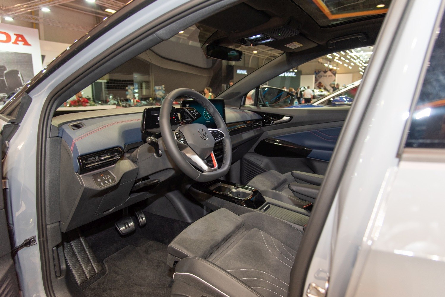 Modern car interior with digital instrument cluster and touchscreen.