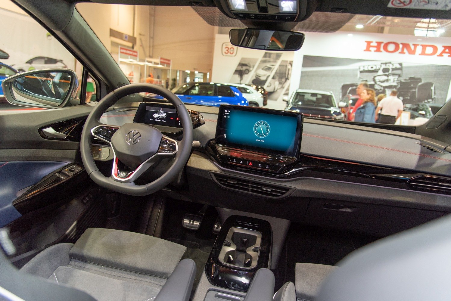 Modern dashboard with digital displays and steering wheel.